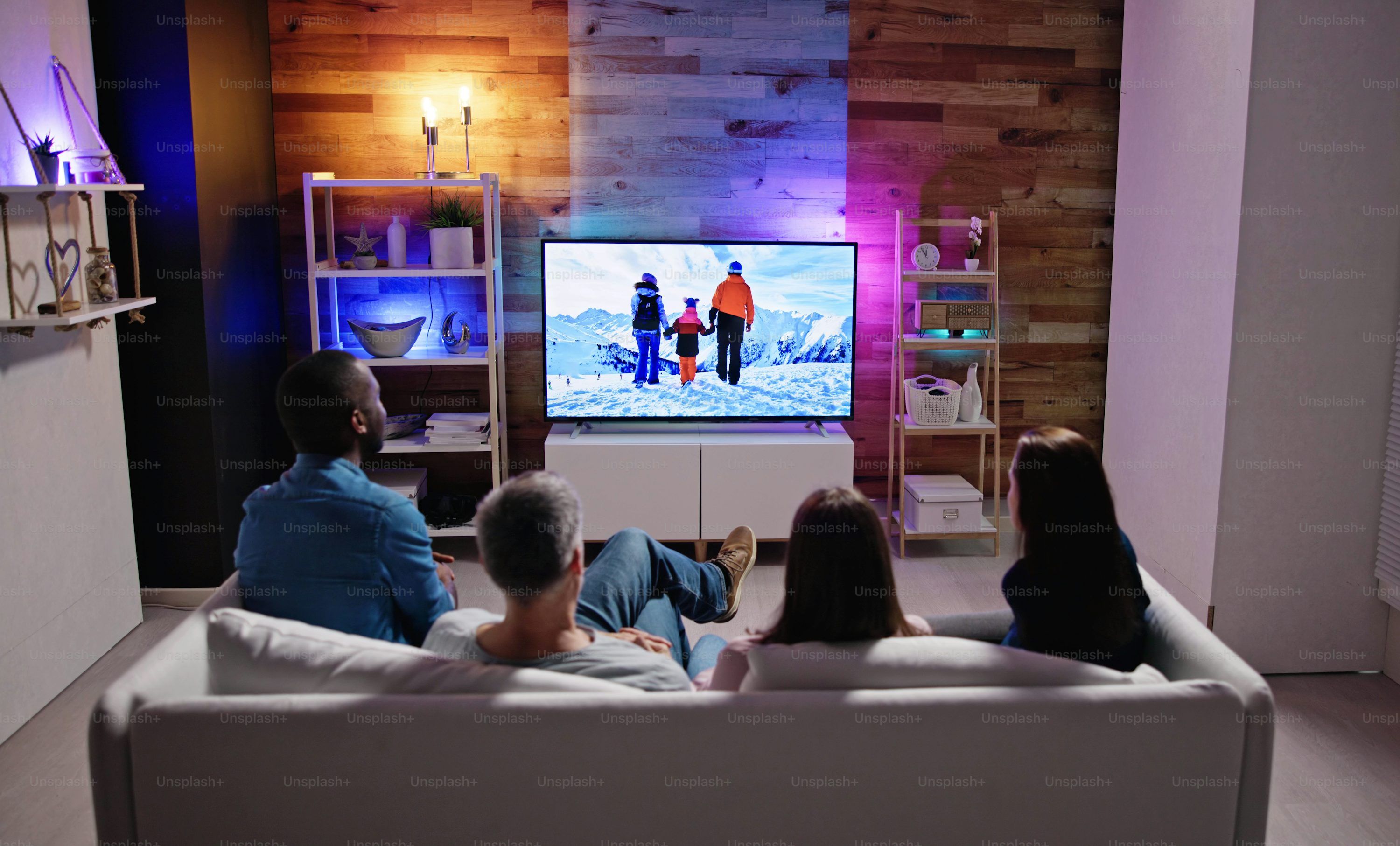 Person relaxing and watching TV with cheap lifetime IPTV on a large screen