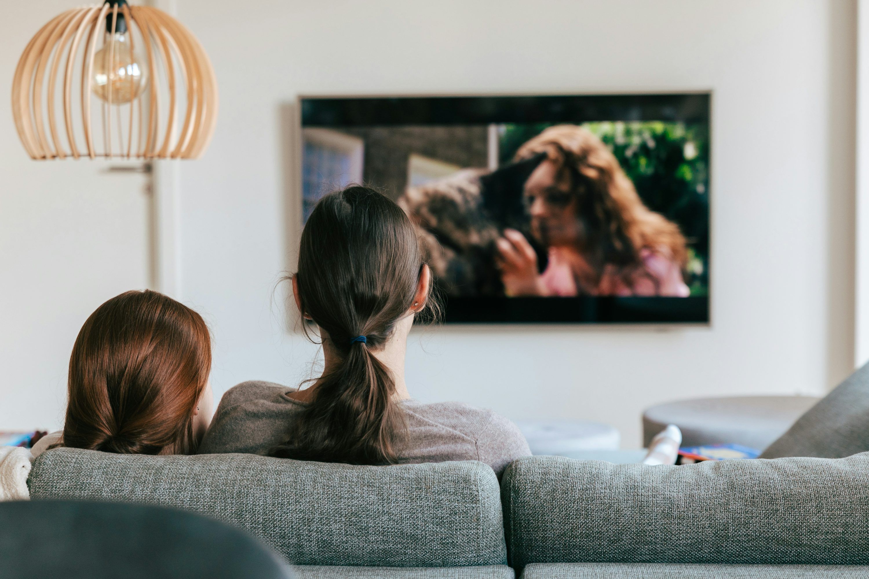 Couple comparing IPTV lifetime vs monthly subscription costs on a laptop at home