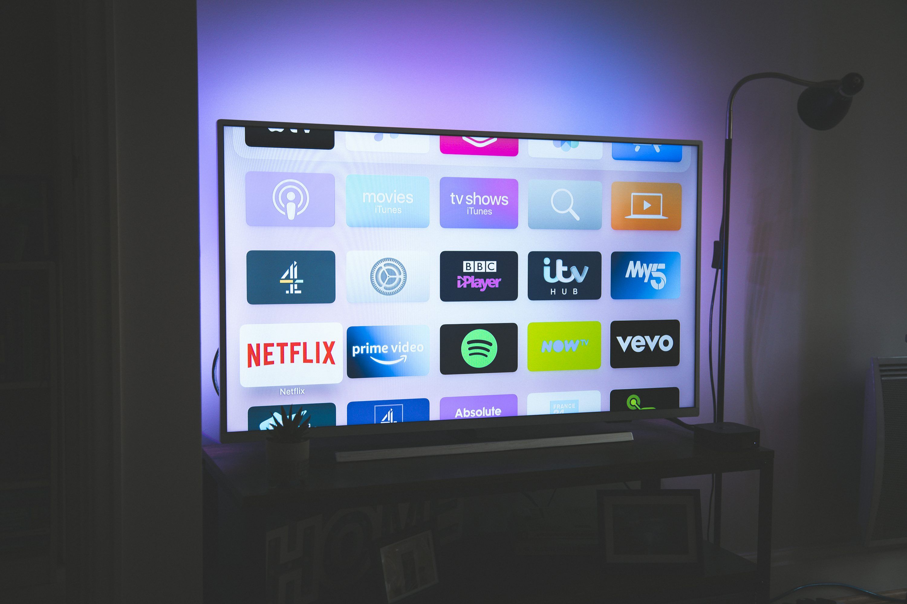 Smart TV remote control with IPTV channel list displayed on screen