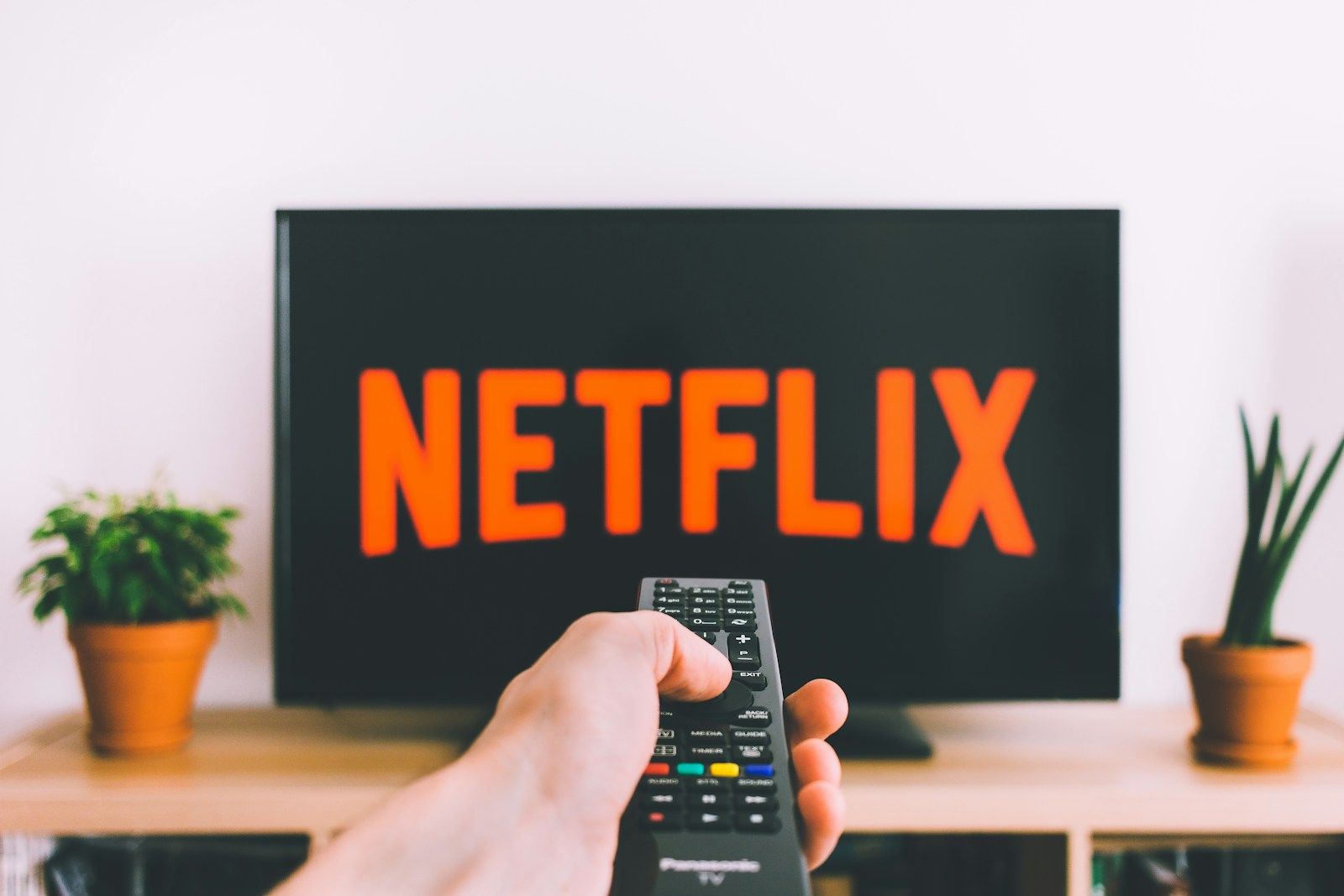Person reviewing monthly IPTV subscription billing on a smartphone, recurring payment comparison